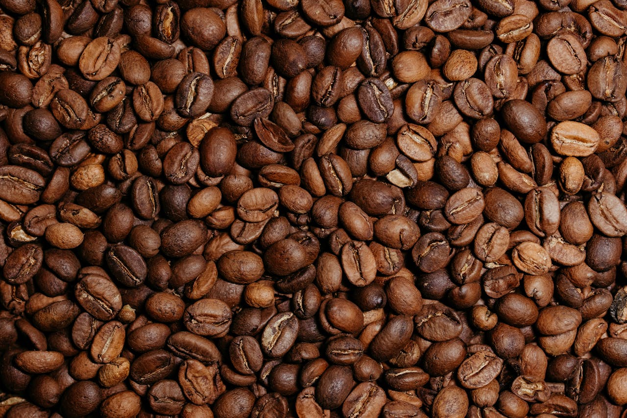 A detailed and textured close-up view of roasted coffee beans, ideal for coffee-related content.